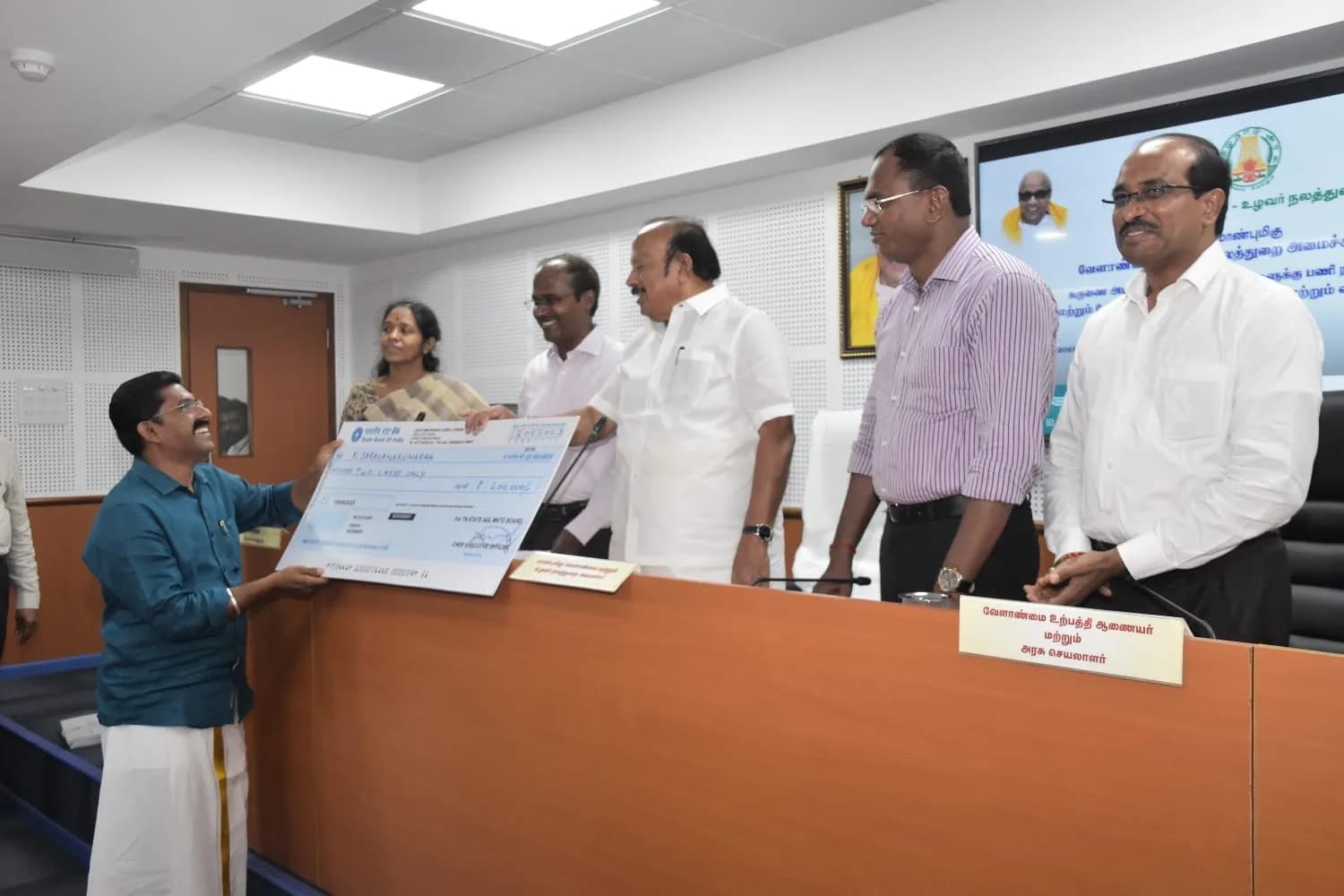 A cheque or certificate presentation at an official event
